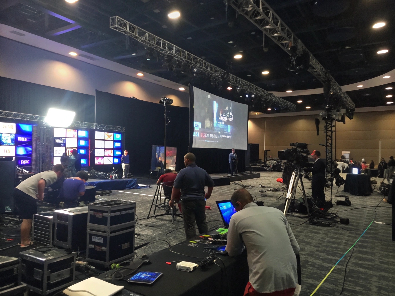 Pre-Event Lighting Execution and Rehearsal A production crew in a huddle during a pre-show technical rehearsal on stage.